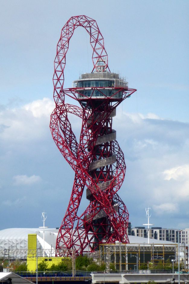 Architecture. A structure like a space needle has a round observation deck on a tall, narrow base. The base spirals up, seeming to hide the structure that must hold the deck up. A net-like tube spews up from the top and turns around the rest the structure like a tangled necklace.